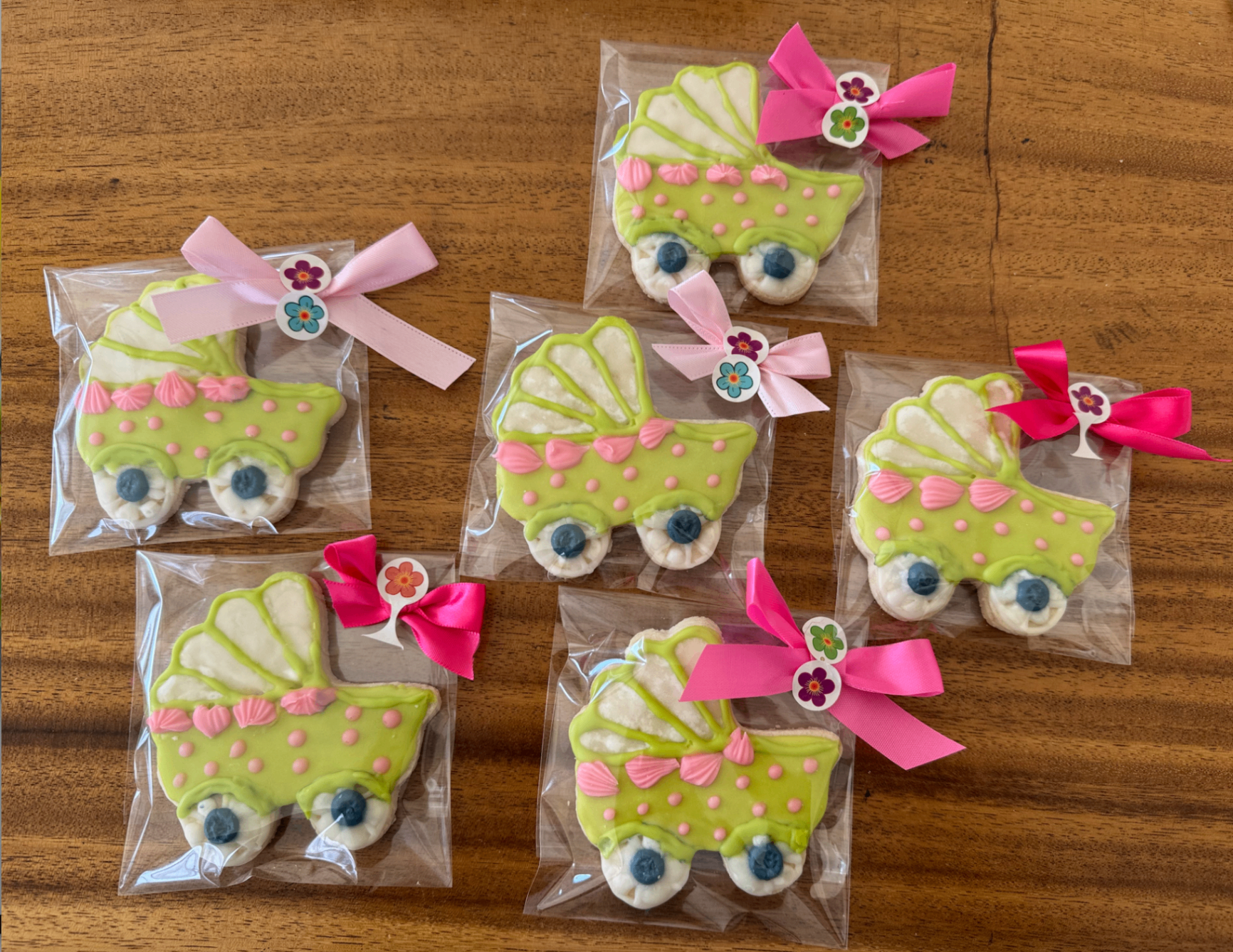 Green baby carriage cookies tied with pink bows
