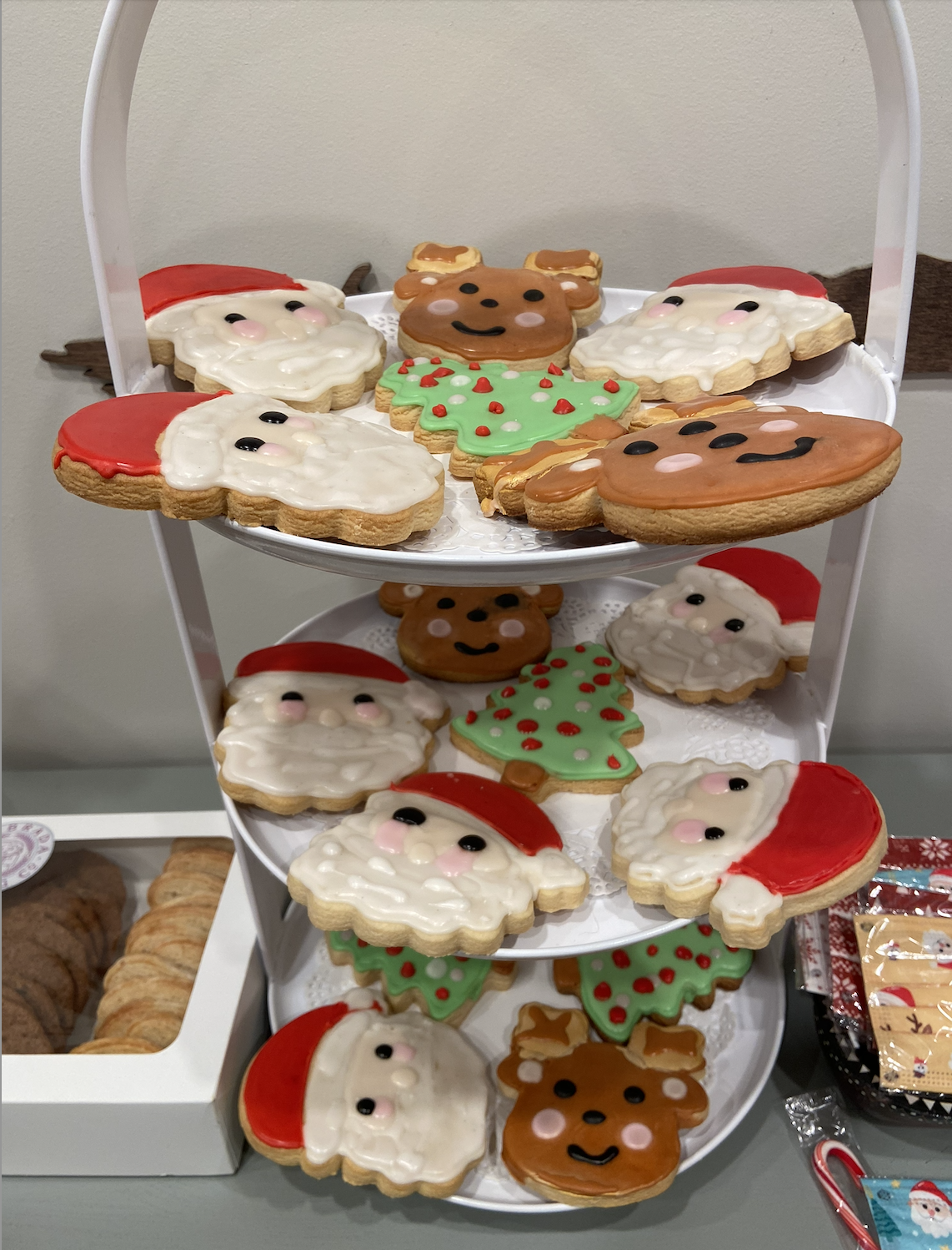 Christmas cookies displayed on a white tiered stand