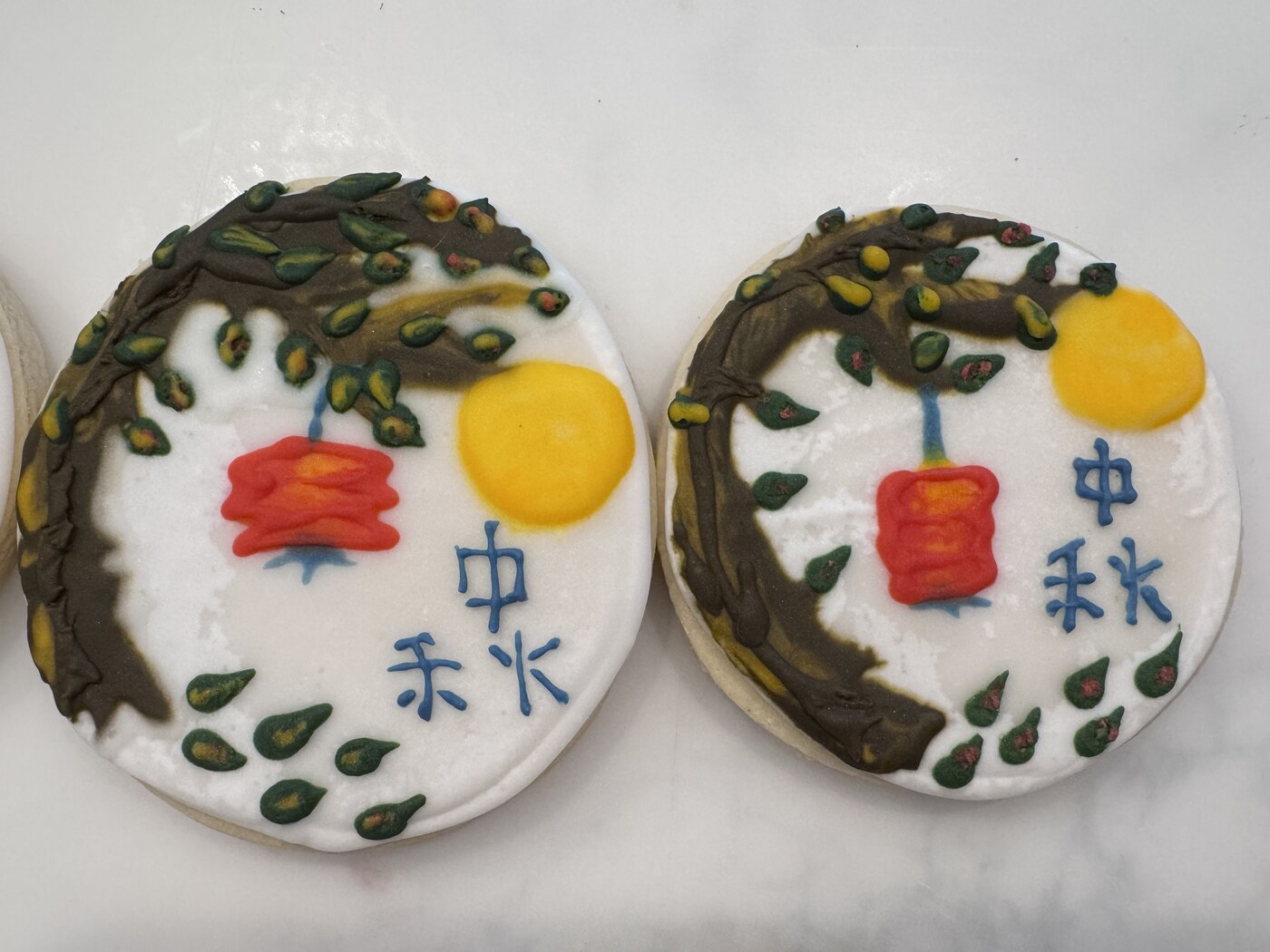Close-up of two Mid-Autumn Festival cookies with lantern and full moon