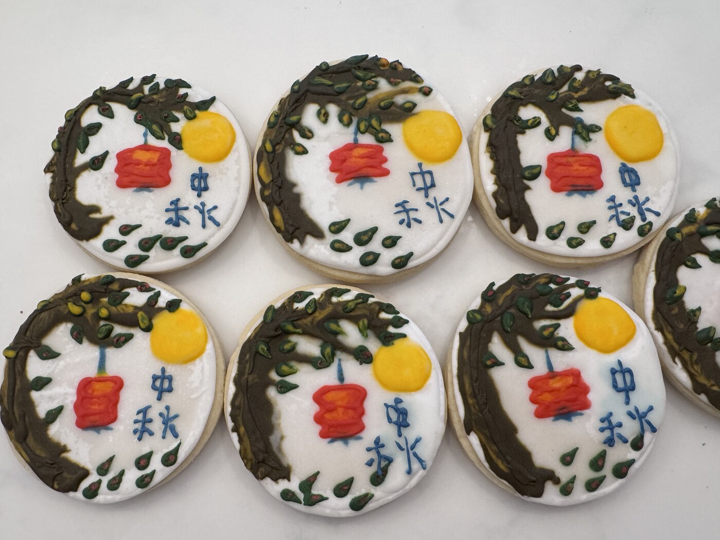 Mid-Autumn Festival cookies with moon, lantern, tree, and Chinese calligraphy
