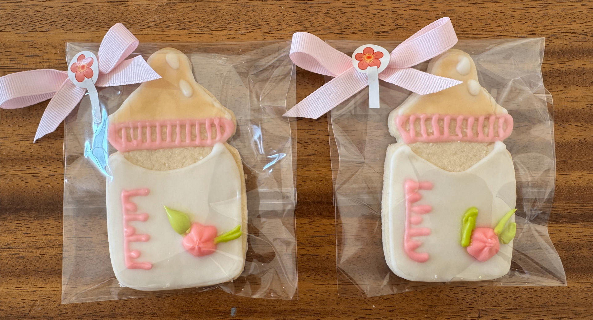 Baby bottle cookies wrapped with soft pink ribbons