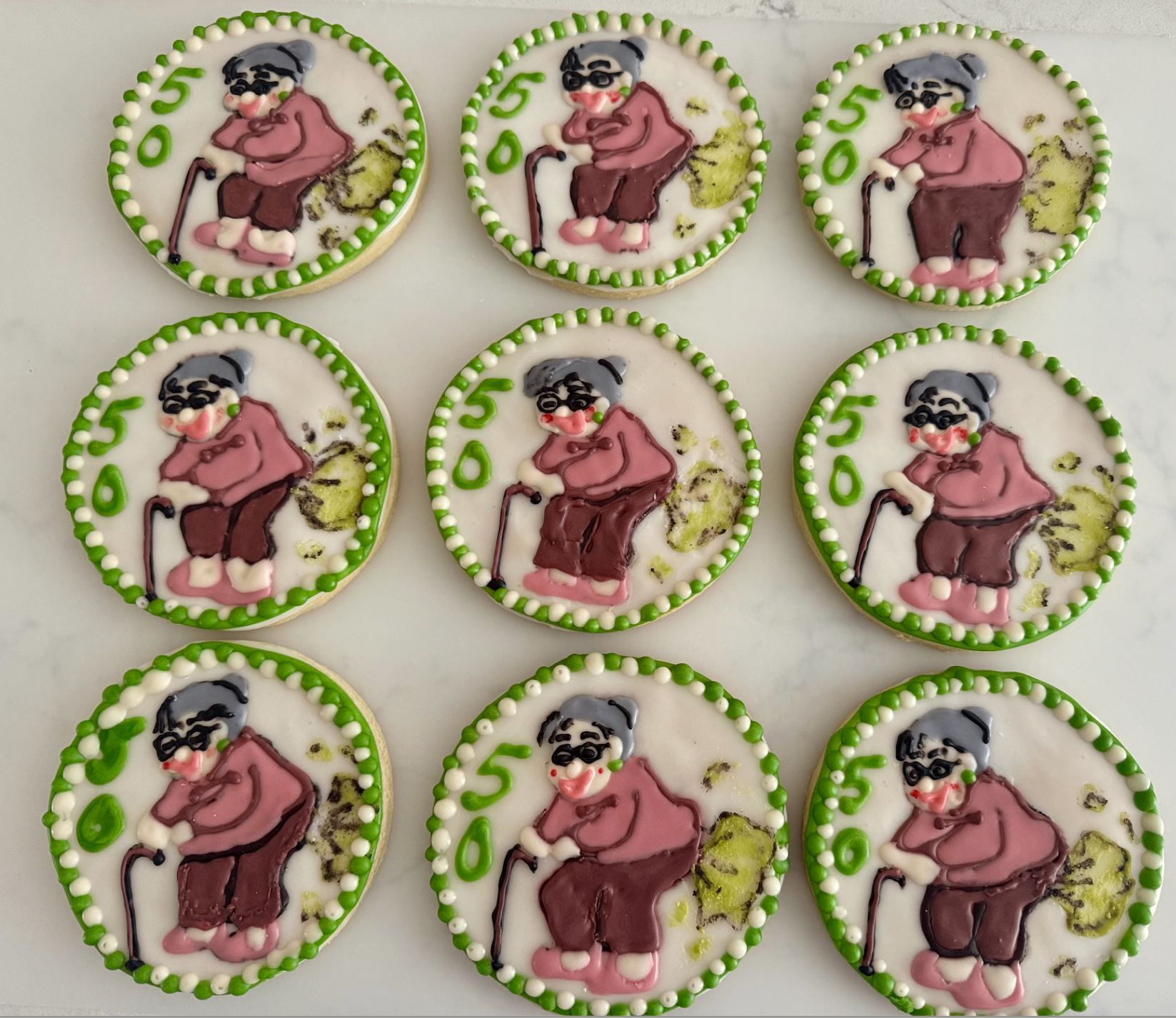50th birthday cookies with hand-painted character design